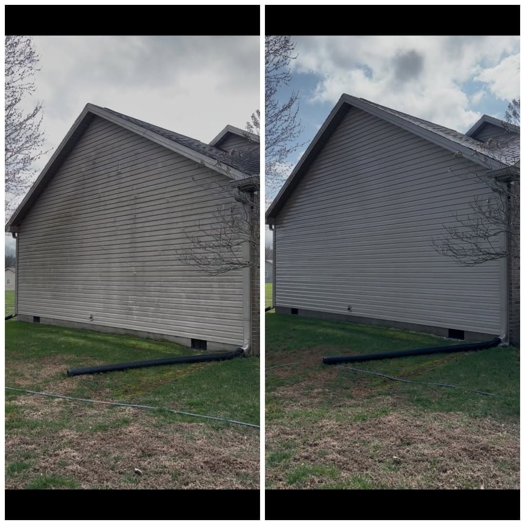 Before and after of a gray gable-end wall, with algae and grime washed away above the lawn